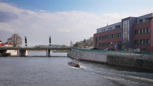 A beautiful shot of a boat sailing along the Weser river in Hameln, Germany