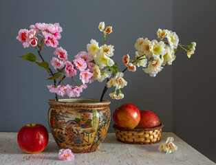 Still life with branches of blossoming sakura and ripe apples. Vintage. Retro.