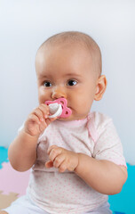 Newborn baby with pink pacifier in mouth