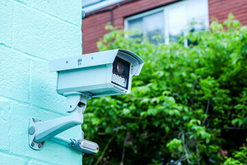 Survilence camera outdoor on building with blue sky