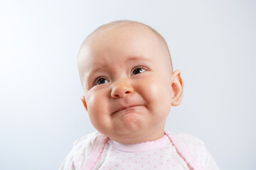 Portrait of a sad newborn baby with an unhappy look