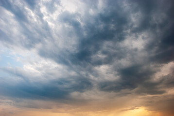 Naklejka na ściany i meble Beautiful storm clouds against the backdrop of sunset skies.