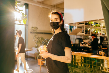 Waitress cleaning glasses in a restaurant