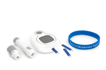Diabetes monitoring and testing equipment kit with blood glucose monitor meter, lancing device, tester strip & type 2 diabetes alert rubber wristband in blue. On white background.