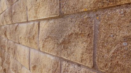 A wall of bricks close-up in perspective.