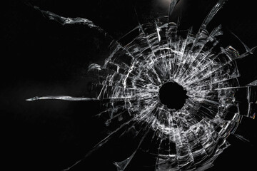 Dirty broken glass with a bullet hole on a black background close-up - obrazy, fototapety, plakaty