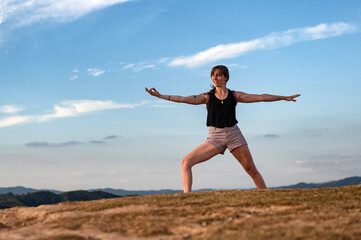 Fototapeta premium young woman exercising alone outdoor on summer with a big blue sky