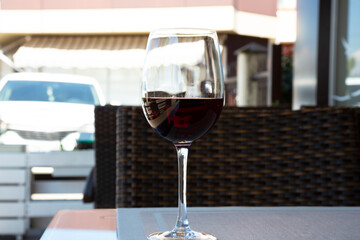 red wine in a large glass on the table in a summer cafe