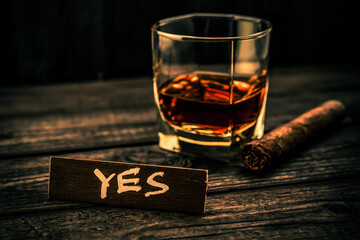 Glass of brandy with the wooden plank on it is an inscription 