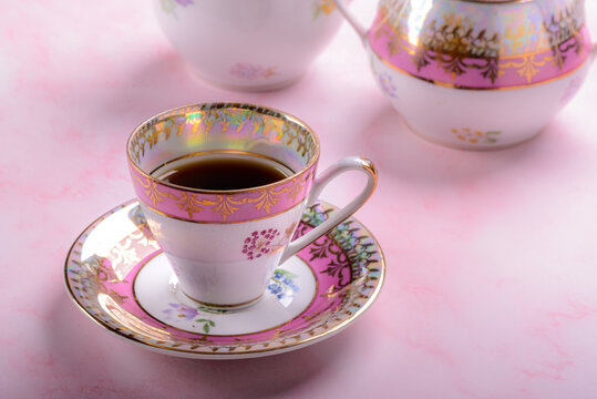 Vintage coffee cup over pink marble.