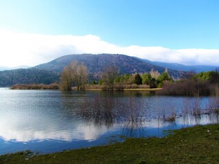 Scenic view of beautiful lake Cerknica or Cerknisko jezero in Notranjska region of Slovenia with blue sky