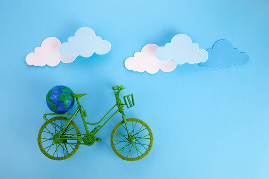 3rd June World Bicycle Day. Green bicycle on blue background. Environment preserve.