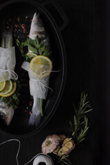Food photography. Fish. Sea ​​bass with lemon and herbs. Dicentrarchus labrax. Photo for recipe book. Sea food.