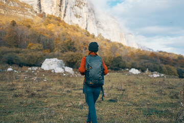 woman in autumn in the forest in nature in the blue sky mountains landscape