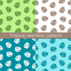 Set of four tropical seamless patterns. Monstera leaves on various backgrounds. Trendy summer style, vector illustration