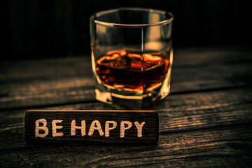 Glass of brandy with the wooden plank on it is an inscription 