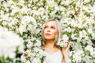 Beautiful girl with light hair, glasses, near flowering trees, Apple tree, spring, branches, flower, fashion, style, European, red