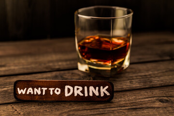 Glass of brandy with the wooden plank on it is an inscription 