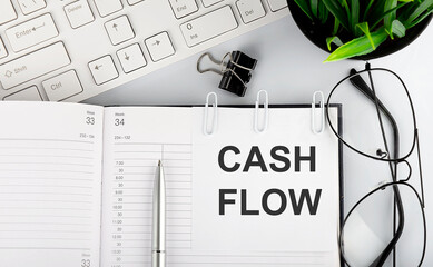 Text CASH FLOW on calendar planner to remind you an important appointment with a pen on isolated white background.