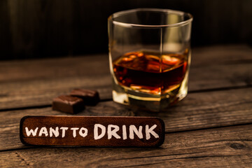 Glass of brandy with chocolate and the wooden plank on it is an inscription 