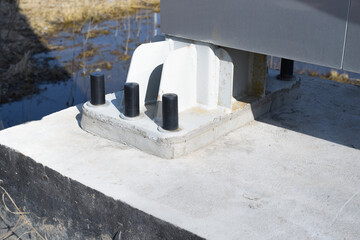 Metal structure fixed to the concrete base with anchors and bolts. Engineering design fixing.