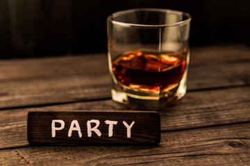 Glass of brandy with the wooden plank on it is an inscription 