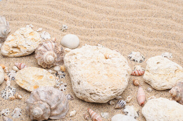 Obraz na płótnie Canvas Summer background of sea sand, stones, seashells, summer vacation concept