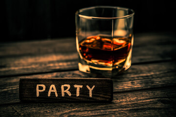 Glass of brandy with the wooden plank on it is an inscription 