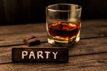 Glass of brandy with chocolate and the wooden plank on it is an inscription 