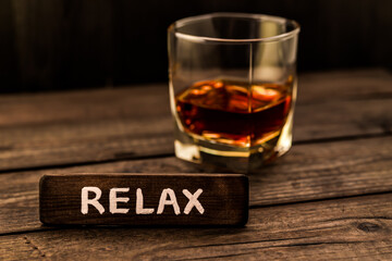 Glass of brandy with the wooden plank on it is an inscription 