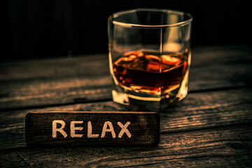 Glass of brandy with the wooden plank on it is an inscription 