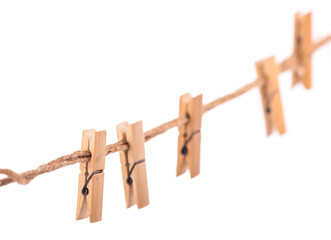 Clothespins with the rope on a white background