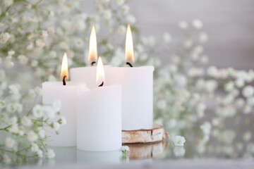 Fototapeta na wymiar Rustic Baby’s Breath Dried white gypsophila flowers and candles on the table. Beautiful wedding decor ideas.