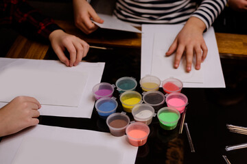 A child draws with colored sand picture. 