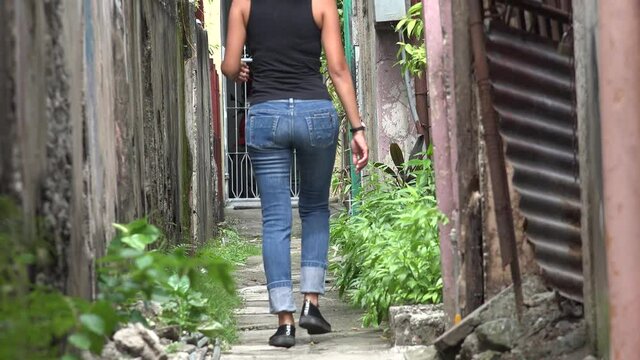 A Woman Walking In Small Alley