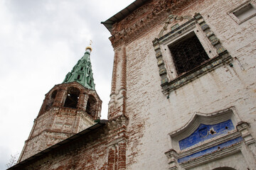 the old cathedral of church and belfry in Dunilovo village with cloudy sky