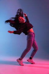 Asian young woman's portrait on gradient colors studio background in neon. Concept of human emotions.