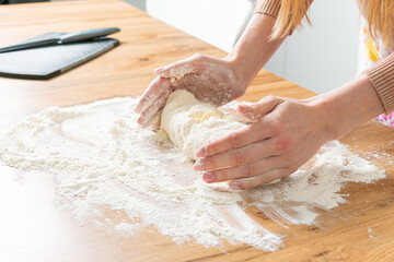 woman preparing dough at the kitchen