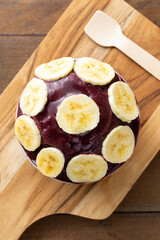 Açai, Brazilian frozen açai berry ice cream bowl with bananas. with fruits on wooden background. Summer menu top view