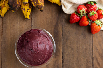 Açai, Brazilian frozen açai berry ice cream bowl. with fruits on wooden background. Summer menu top view