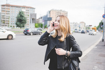 Young beautiful caucasian blonde hair woman outdoor in the city, talking smart phone smiling - technology, communication, happiness concept