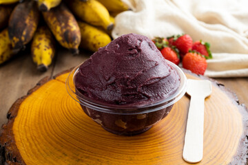 Açai, Brazilian frozen açai berry ice cream bowl with strawberries and bananas. with fruits on wooden background. Summer menu front view