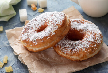 Classic doughnut sprinkled with powdered sugar. Sweet doughnuts.