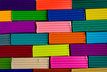 Colored plasticine for modeling on a white background.