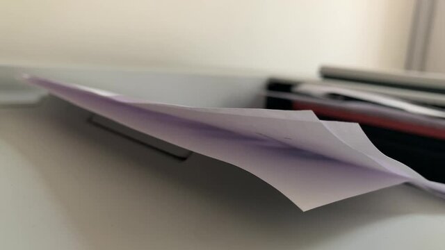 Office printer prints on paper, close-up. Office equipment for printing and copying documents.