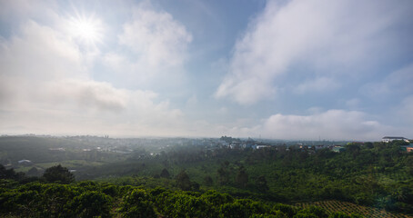 Sun rays and misty at the valley on Bao Loc town. The far side is Tan Hoa Church in Lam Dong province, Vietnam.