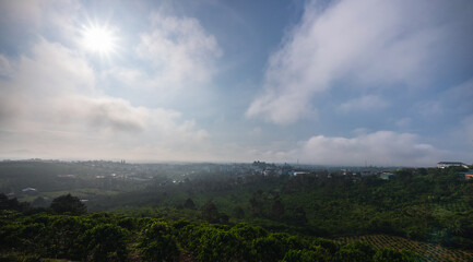 Sun rays and misty at the valley on Bao Loc town. The far side is Tan Hoa Church in Lam Dong province, Vietnam.