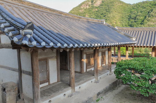 Korean Confucian Academy from Joseon Dynasty era. View of eastern dormitory, courtyard with small tree and pavilion in back. Byeongsan Seowon, Andong, South Korea.