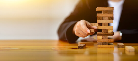 Abstract businesswomen fail danger tower block game building construction protect plan and project control with copy space.