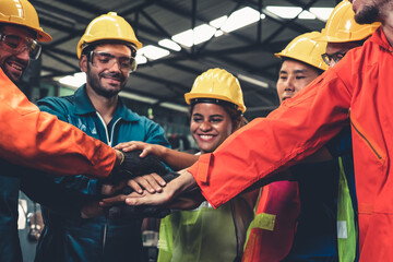 Skillful worker stand together showing teamwork in the factory . Industrial people and manufacturing labor concept .